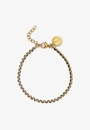 Bracelet en chaîne dorée avec perles noires, doté d'un fermoir à homard et d'un charme circulaire avec une bordure décorée. Longueur ajustable.