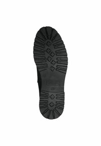 Semelle en caoutchouc noir avec un profond profil, présentant des motifs croisés et des détails texturés, conçue pour l'adhérence et la durabilité.