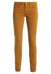 Mustard yellow skinny jeans made of cotton, featuring five pockets, a zip fly, and a front button closure. Smooth texture with minimal detailing.