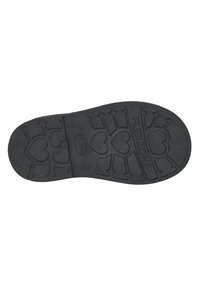 Suela de zapato de goma negra con una superficie texturizada, que presenta patrones de corazones cortados y líneas, etiquetada como "FLEX-ZONE" y "22."