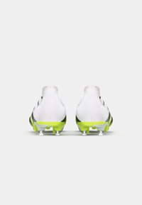 White football boots with black accents, a textured finish, and a bright green sole. Features clear studs for traction.