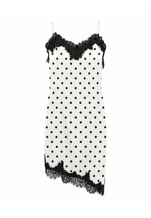 Vestito smanicato bianco con pois neri, rifinitura in pizzo nero sullo scollo e orlo asimmetrico, con sottili spalline bianche.