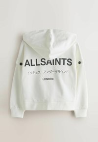Sweat à capuche blanc avec texte noir indiquant "ALLSAINTS" et "LONDON". Comprend des manches longues et des détails à boutons sur les épaules.