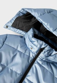 Svijetloplavi kaput s odbojnom podlogom, crnim patentnim zatvaračem i odvojivom kapuljačom, prikazan ravno s vidljivim ovratnikom i gornjim dijelom prsiju.