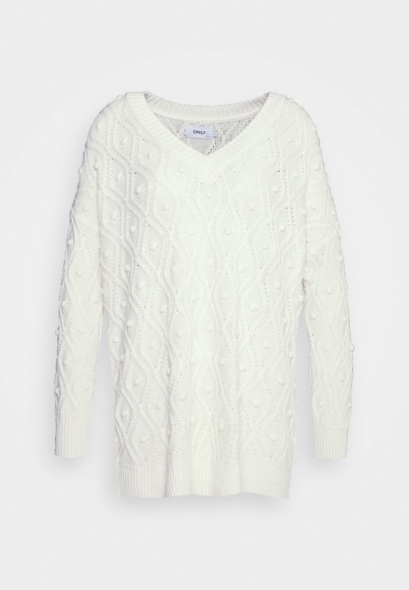 Suéter blanco de punto con cuello en V, que presenta un patrón de diamantes texturizado y detalles de pompones. Manga larga y puños acanalados.