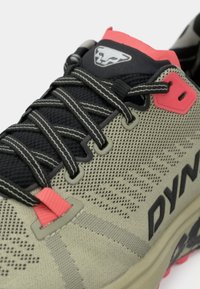 Ελαφρύ αθλητικό παπούτσι τρεξίματος με επάνω μέρος από διχτυωτό υλικό σε ελαιόχρωμο, μαύρους κορδόνια, ροζ λεπτομέρειες και ανθεκτική σόλα με υφαντή επιφάνεια.