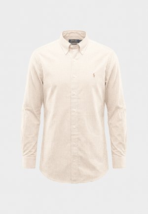 Ilgas rankovėmis marškiniai su smėlio ir baltos spalvos languotu raštu, užsegami mygtukais ir su apykakle, kurios galai užsegami mygtukais, kairėje krūtinės pusėje yra mažas siuvinėtas logotipas.