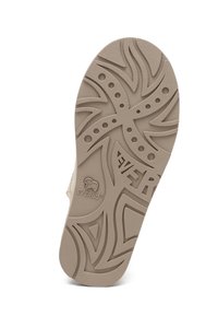 Beige rubber shoe sole featuring a textured design with swirling patterns and circular accents; logo detail embossed on the side.