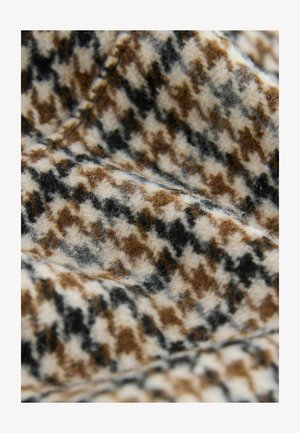 Woolen tkanina s houndstooth vzorom v bežnih, rjavih in črnih odtenkih. Mehka tekstura z vidnimi vlakni in podrobnostmi šivanja.