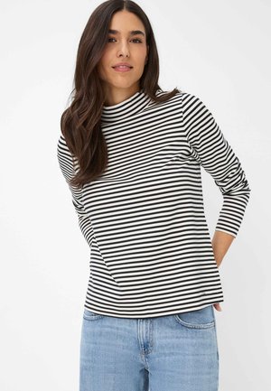 Striped long-sleeve top in black and white, featuring a high neck and narrow stripes. Material appears soft; subtly tapered fit.