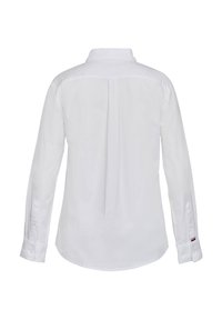 White long-sleeve button-up shirt with a central back pleat and small red, white, and blue striped detail on left cuff.