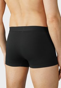 Svarta stretch-cotton boxerkalsonger med sömlös midja, åtsittande design och slät textur. Lämpliga för vardagligt bruk.