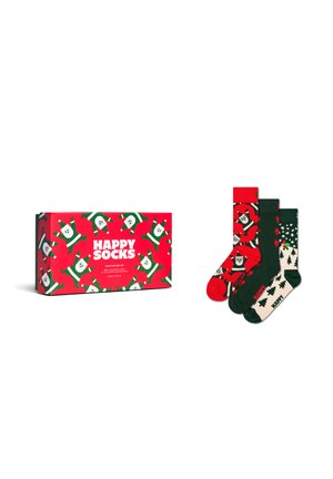 Set von drei weihnachtlichen Crew-Socken mit Santa- und Baum-Mustern neben einer passenden roten Geschenkebox, die mit "Happy Socks" beschriftet ist.
