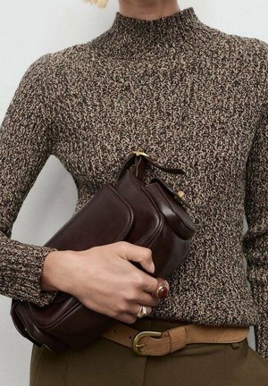 Person iført brun tekstureret sweater og beige bælte, der holder en mørkebrun læderhåndtaske med guldfarvet beslag.
