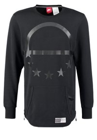 Svart sweatshirt i mjukt tyg, med en glänsande grafisk design med stjärnor och en framfick, accentuerad av dragkedjeförsköning.