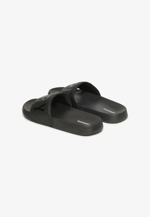 Black slide sandals made of synthetic material featuring wide straps with embossed branding. Smooth texture and lightweight design.