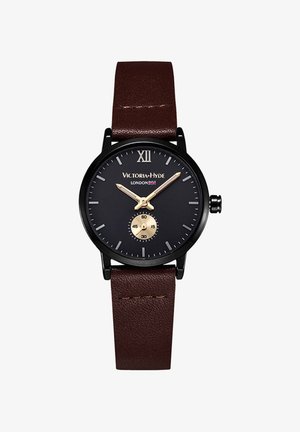 Czarny analogowy zegarek z złotą sekundową wskazówką, ciemnoniebieską tarczą, brązowym skórzanym paskiem oraz rzymską cyfrą XII na pozycji 12.