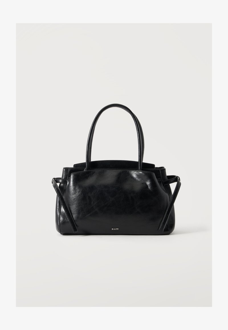 Sac à main en cuir noir avec doubles poignées, sangles latérales et petit logo "RAID" sur le devant, présenté sur un fond clair uni.