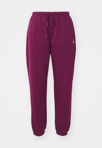 Paarse joggingsbroek van zachte stof, met een elastische tailleband met koordjes en afgeknipte enkels. Kleine logo-accent aan de zijkant.