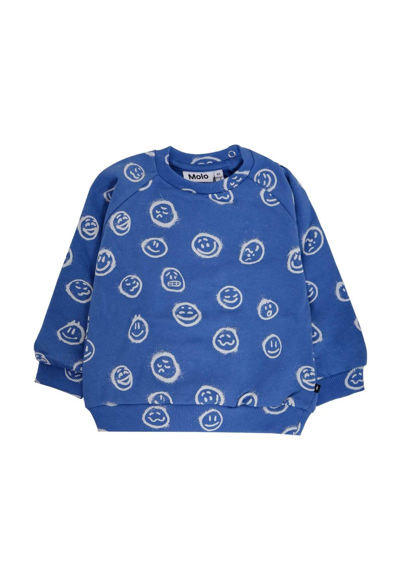 Sweatshirt bleu avec des imprimés de visages souriants blancs, col ras du cou et poignets côtelés. Fabriqué en tissu doux et texturé. Étiquette de marque visible.