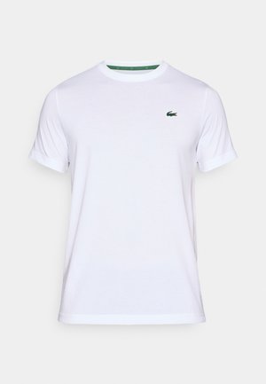 T-shirt bianca in cotone con scollo rotondo, maniche corte e piccolo logo verde Lacoste sul lato sinistro del petto. Tessuto morbido e vestibilità classica.