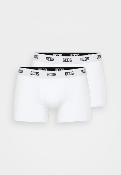 White boxer briefs featuring a black waistband with "GCDS" and "2023" printed in white. Smooth texture, fitted design, two-pack set.