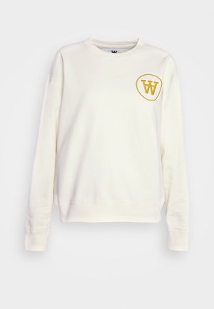 Cremefarbener Sweatshirt mit langen Ärmeln, rundem Ausschnitt und einem runden gelben Logo auf der linken Brust. Hergestellt aus weichem Stoff.