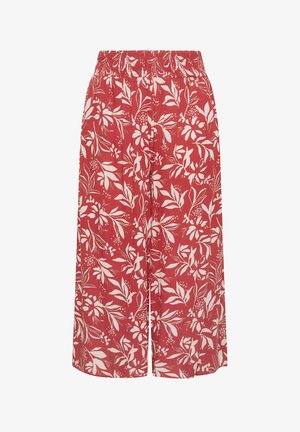 Pantalones anchos rojos con cintura elástica, decorados con un patrón blanco de flores y hojas por todo el tejido.