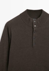 Pullover marrone a maglia con colletto alto, dotato di una placca con bottoni e quattro bottoni neri, e una finitura testurizzata.