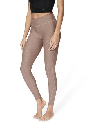 Leggings in una tonalità di marrone tenue con un delicato motivo a leopardato. Design a vita alta con dettagli di cucitura a contrasto.