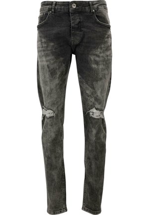 Slim fit, izbledele črne kavbojke iz denima z obrabljenimi kolenskimi zaklopkami. Imajo standardne žepe in gumbasto zapiranje.