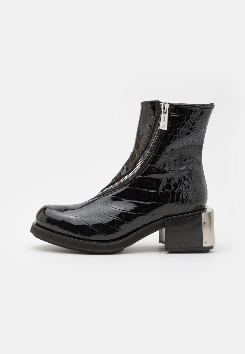 Black patent leather ankle boot with crocodile texture, curved toe, side zipper, and square metallic heel detail.