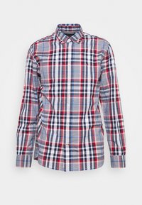 Chemise à manches longues boutonnée avec motif à carreaux rouge, blanc, marine et bleu et col pointu sur fond blanc.