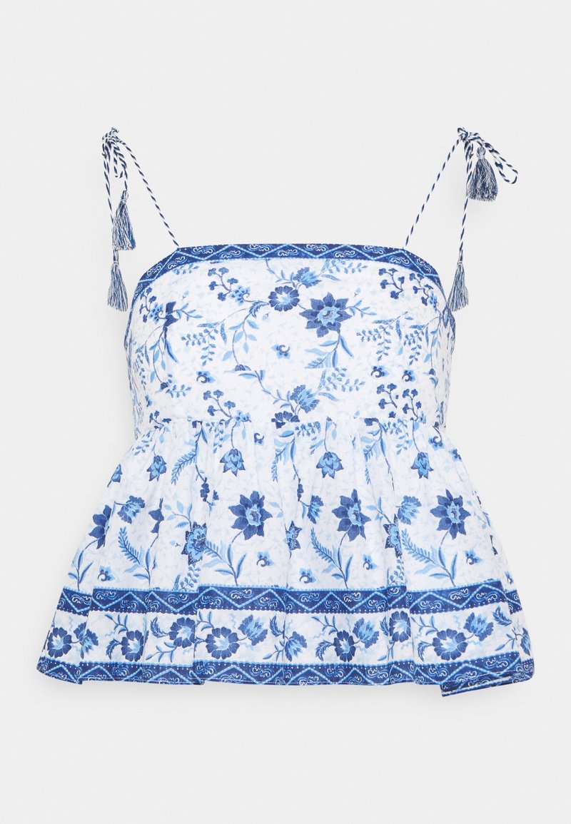 Haut blanc sans manches avec imprimé floral bleu, liens à franges aux épaules et bordure à motifs le long de l'encolure et de l'ourlet.