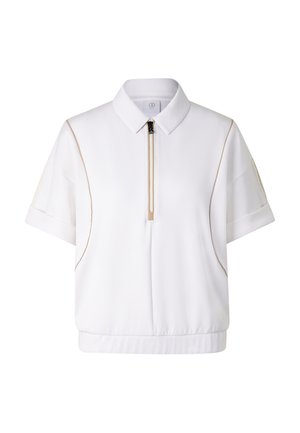 Chemise blanche à manches courtes avec col, fermeture éclair devant, passepoil beige sur les côtés, petite poche sur chaque manche, ourlet élastique en bas.