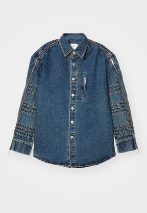 Denim shirt featuring a button front, long sleeves, and a zippered chest pocket. Blue color with textured accents on sleeves.