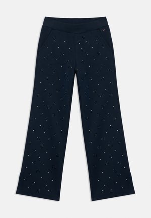 Navyblauwe wijde broek gemaakt van zacht materiaal, met verspreide strassaccenten en twee zijzakken voor extra detail.