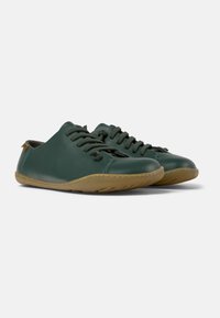 Green leather shoes with a rounded toe, lace-up design, and rubber outsole. Features a textured finish and contrasting tan sole.