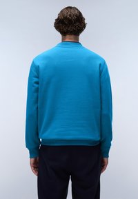 Turqoise sweatshirt gemaakt van zachte katoen, met een geribde kraag en manchetten, in een ontspannen pasvorm. De achteraanzicht toont een gladde textuur en een effen kleur.