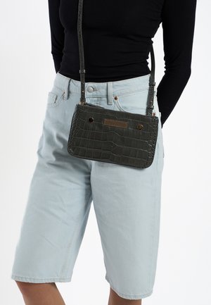 Dark green, faux crocodile leather crossbody bag with a structured shape, textured surface, gold-tone accents, and adjustable strap.