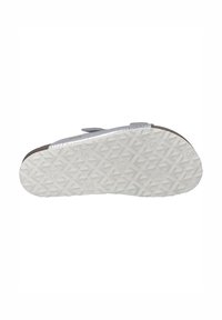 Sandal bottom with a textured white rubber sole featuring arrow patterns and a light blue upper with a smooth, shiny finish.