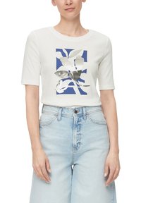 Witte T-shirt met korte mouwen, voorzien van een blauwe rechthoekige grafiek met zilveren botanische afdrukken, gedragen met lichtblauwe wijde jeans.