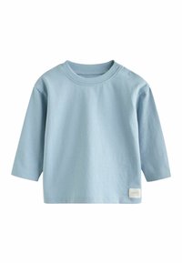Lichtblauw langemouw shirt van katoen, met een ronde halslijn, twee schouderknopen en een klein label aan de onderkant links.