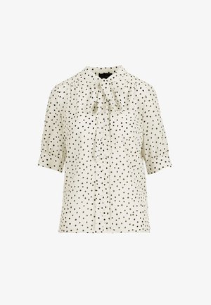 Blusa a maniche corte in tessuto color crema con pois neri, dotata di collo con fiocco, spalle plissettate e chiusura frontale con bottoni.