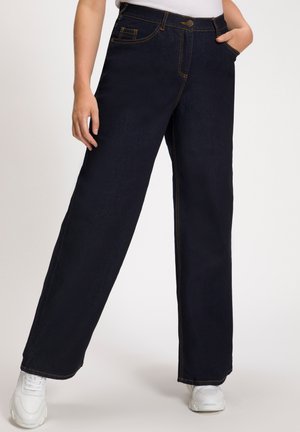 Donkerblauwe wijde spijkerbroek van denim. Voorzien van contrasterende stiksels, voorzakken en een knoopsluiting. Soepele textuur, casual ontwerp.