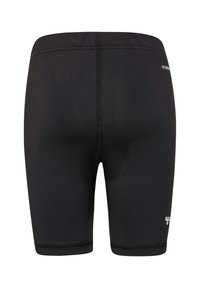 Svarta träningsshorts med en åtsittande passform, tillverkade av ett slätt material. Har flat sömmar och en liten logotyp på sidan.