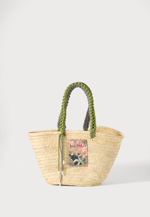 Vævet beige stråtaske med flettede grønne og sorte håndtag og en farverig rektangulær lap foran.