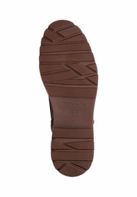Semelle de chaussure en caoutchouc marron avec des motifs texturés, comportant une variété de rainures et de crêtes pour une meilleure adhérence. L'empreinte du logo est visible. Taille 37.