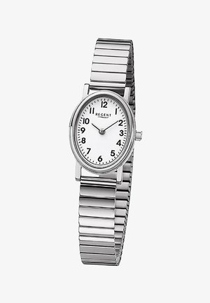 Montre-bracelet ton argent avec un cadran ovale blanc, des chiffres arabes noirs, des aiguilles des heures et des minutes noires, et un bracelet extensible en métal.