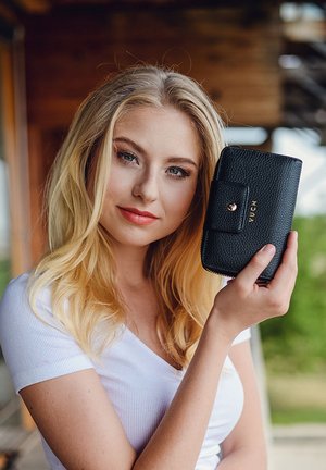 Black textured wallet with a zip closure and a flap featuring a gold snap button. Brand name "VUCH" embossed in gold.